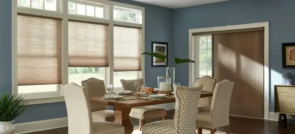 Dining room with table set for a meal, a vase with greenery, and window blinds. Blue walls.
