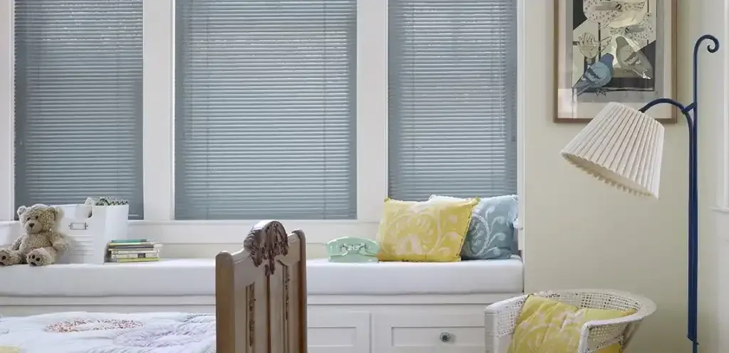 Window seat with aluminum mini blinds lowered over the glass