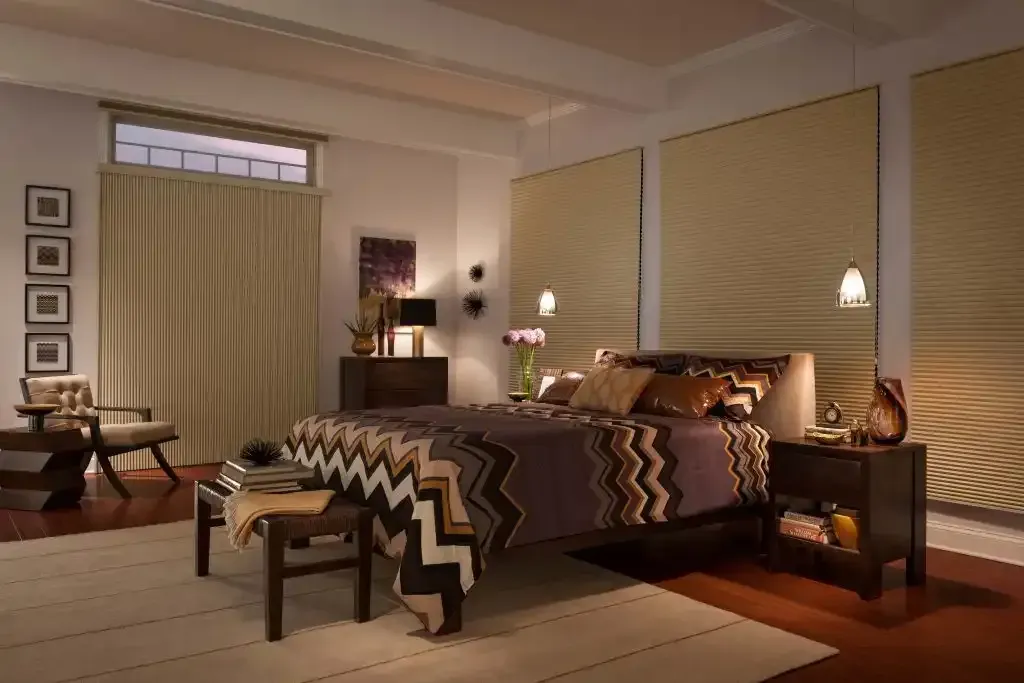 Bedroom with cellular shades fully lowered over the windows