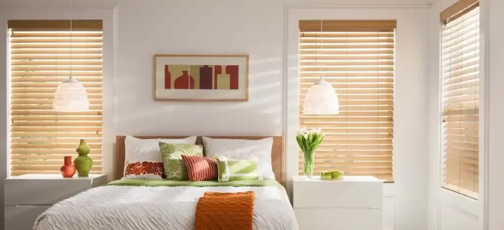 Bright bedroom with faux wood blinds on the window