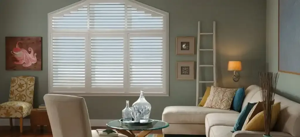 Living room with plantation shutters fitted to an arched window