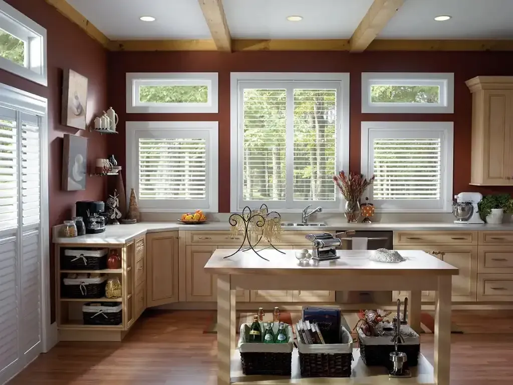 Kitchen with red walls and white plantation shutters on the window