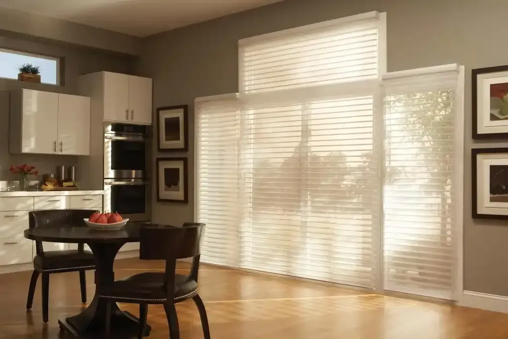 Kitchen dining nook with a round table and sheer shadings on tall windows