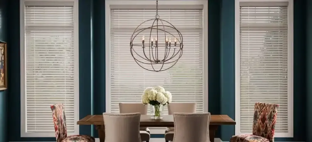 Dining room with teal walls and wood blinds on the windows